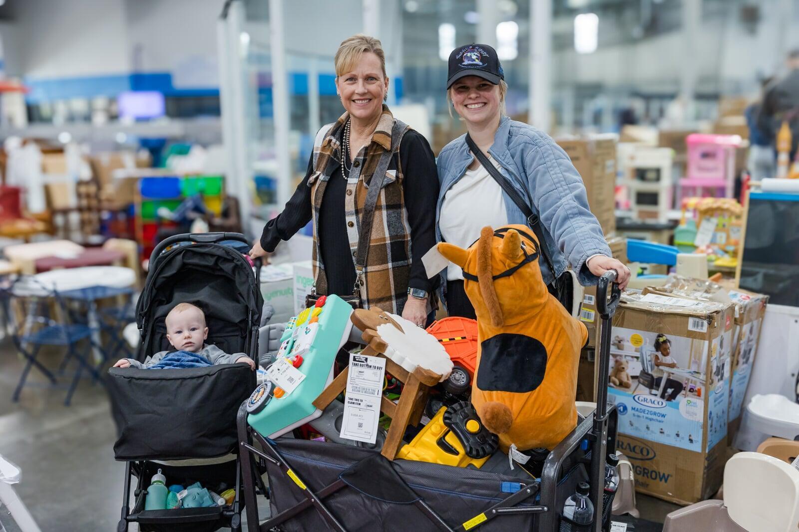 A cashier smiles behind her mask as she gets ready to check out the next happy JBF customer.